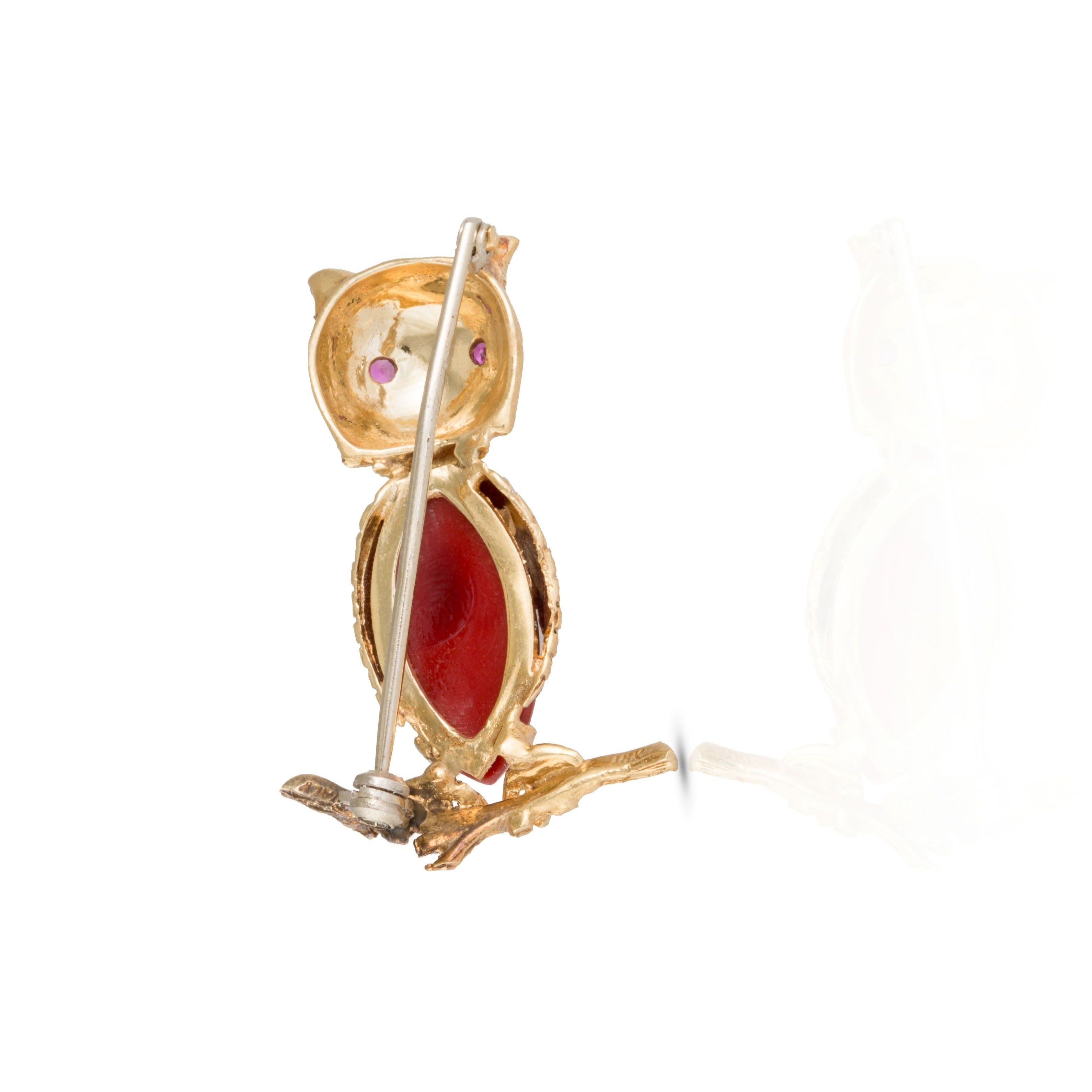 Closure side of gold, glass, and ruby brooch.