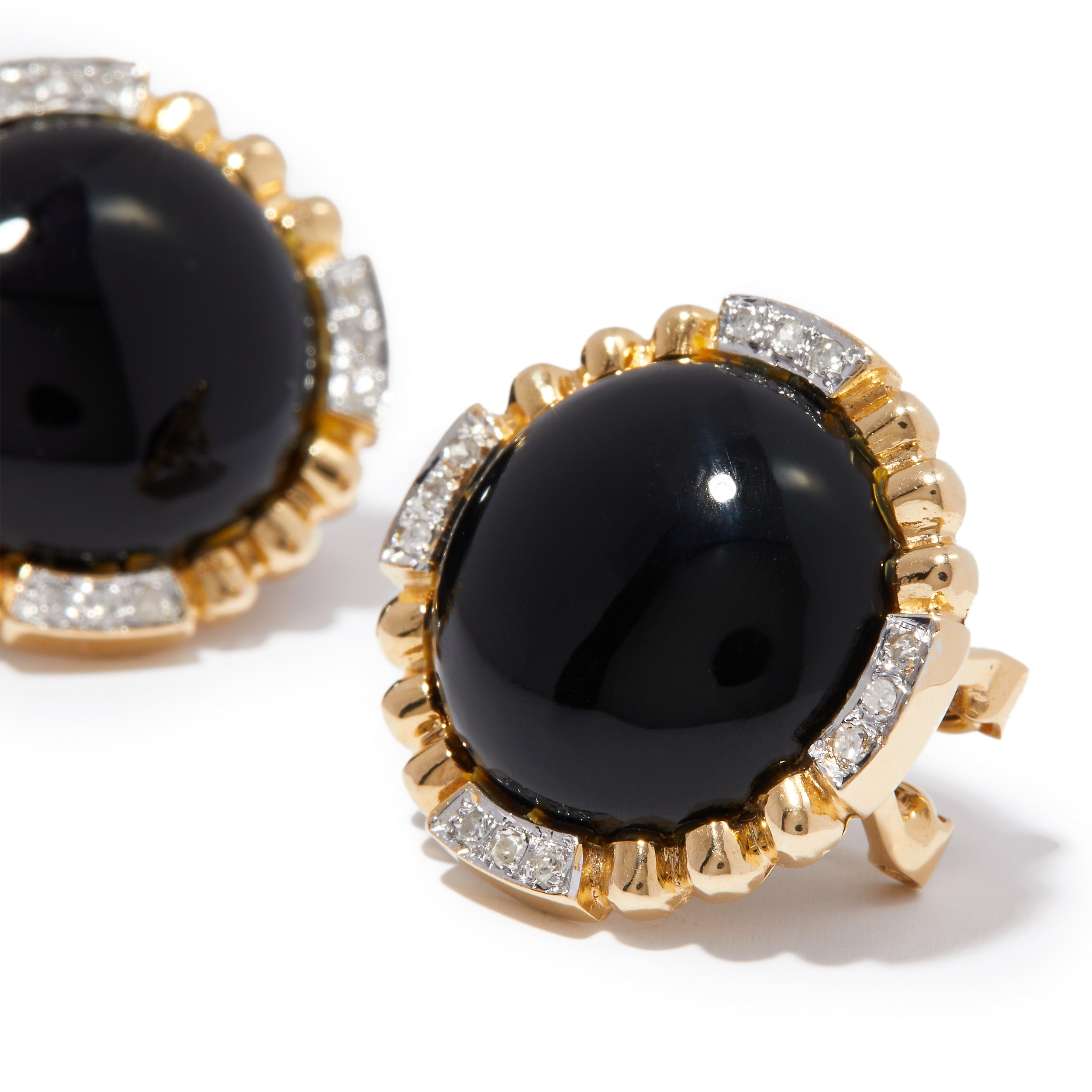 Side view of black glass button earrings in 14ct gold and diamonds.