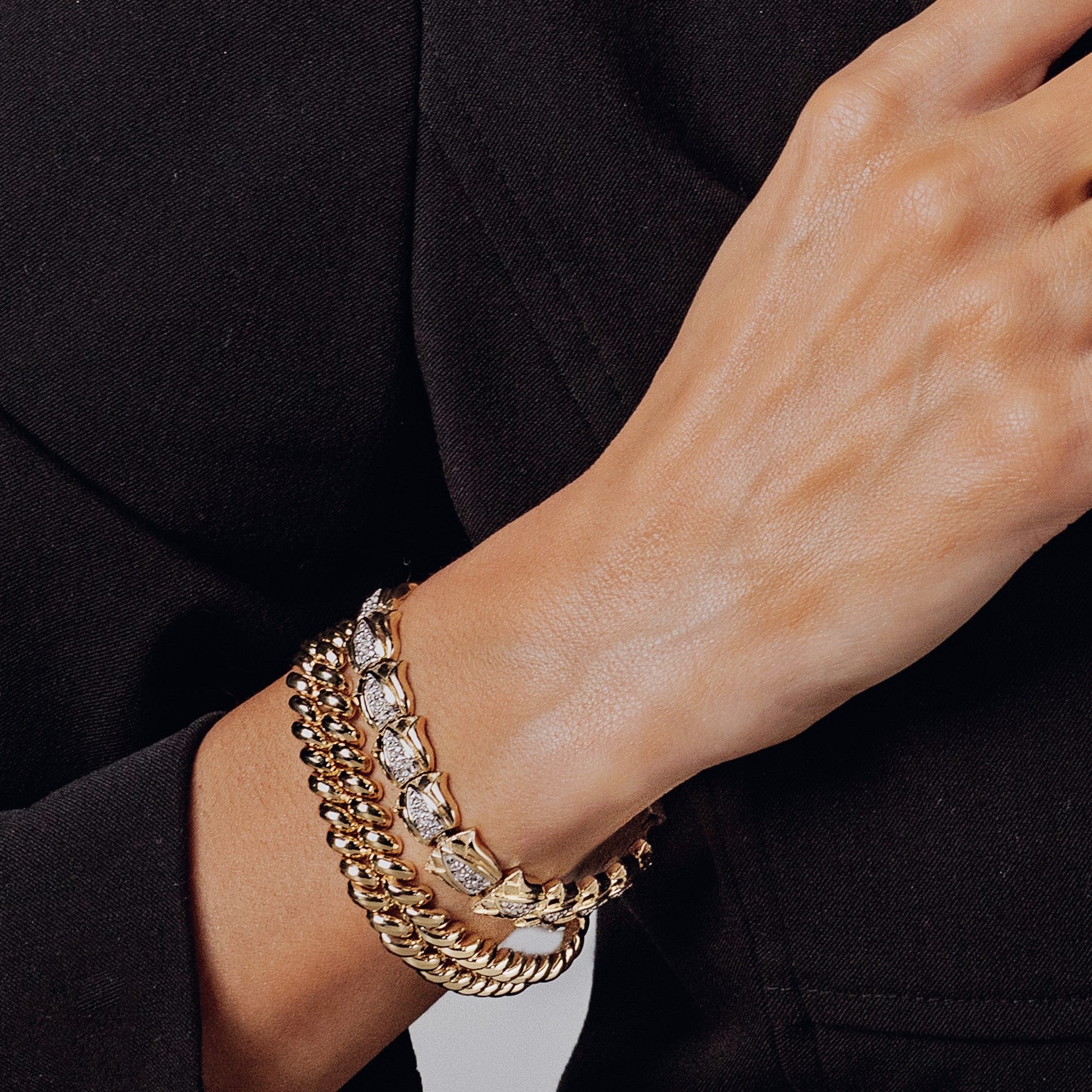 Lotus flower and San Marco bracelets worn on a woman’s wrist.