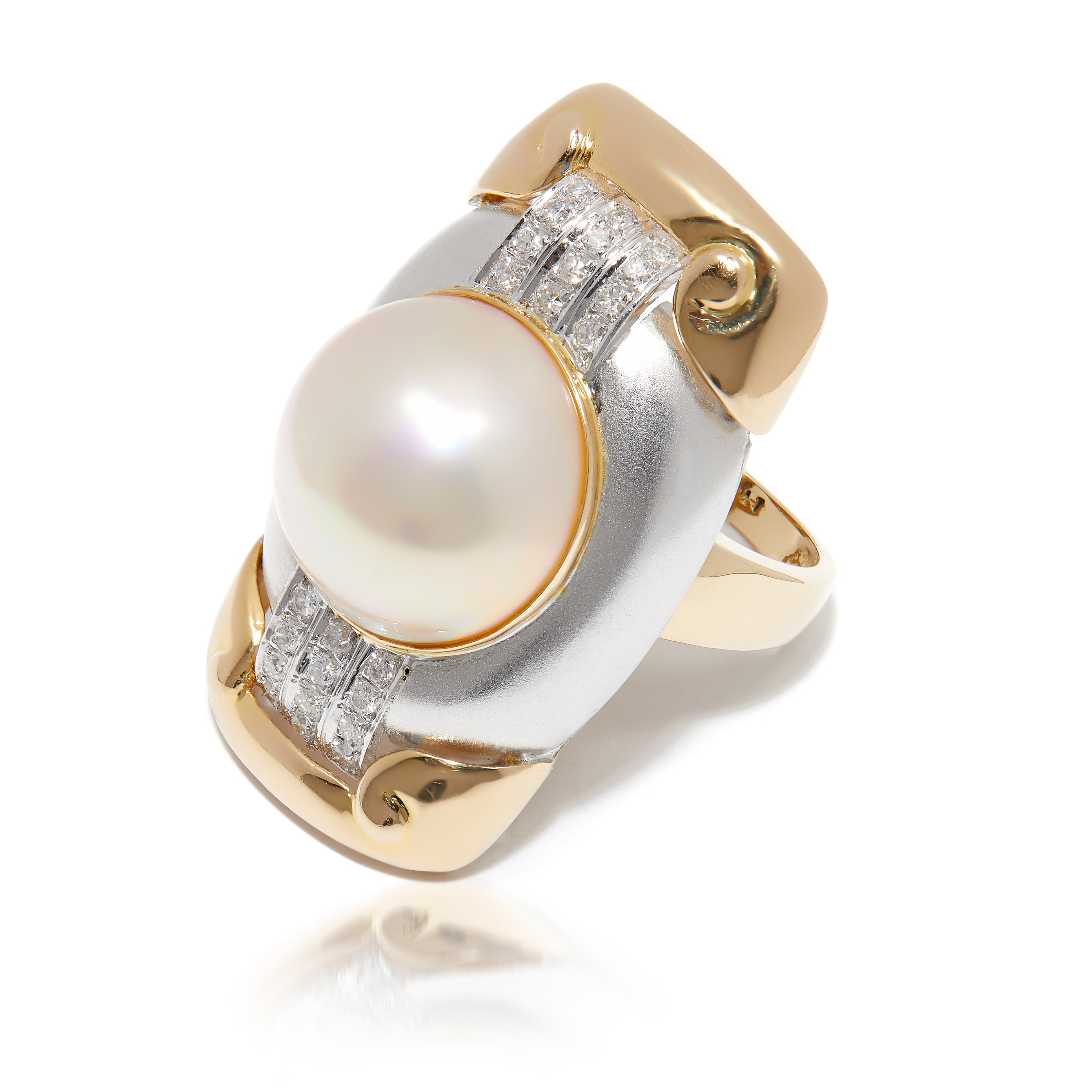 Elongated two-tone gold pearl ring with diamond accents.