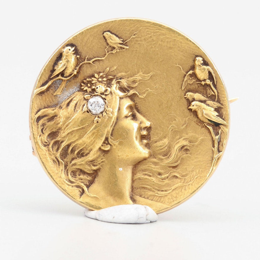 Antique-Pictorial-Gold-Diamond-broochAntique brooch to pendant with a diamond-accented portrait of a lady looking at birds. 