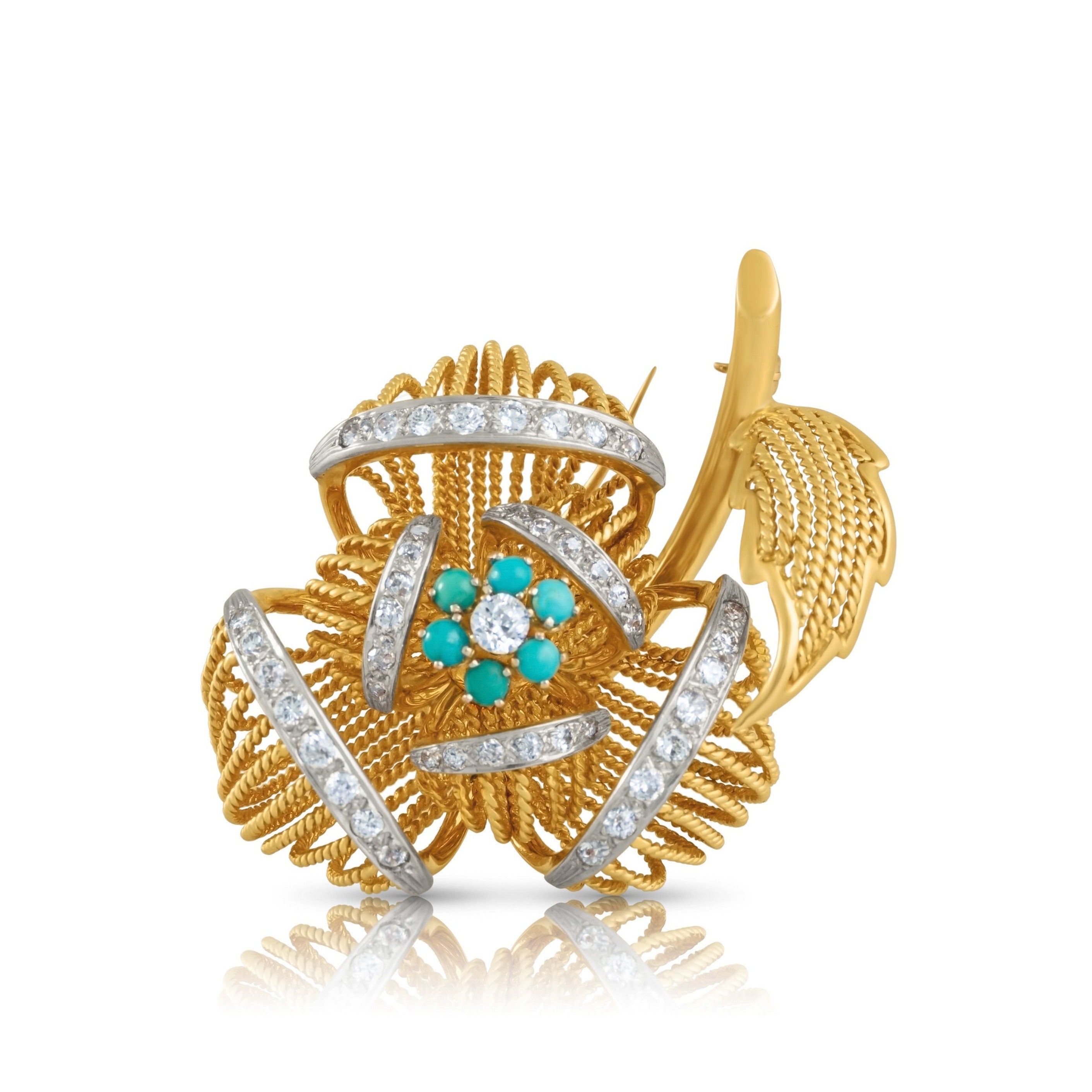 Flower brooch/fur clip in gold and platinum with diamonds and turquoise centre.