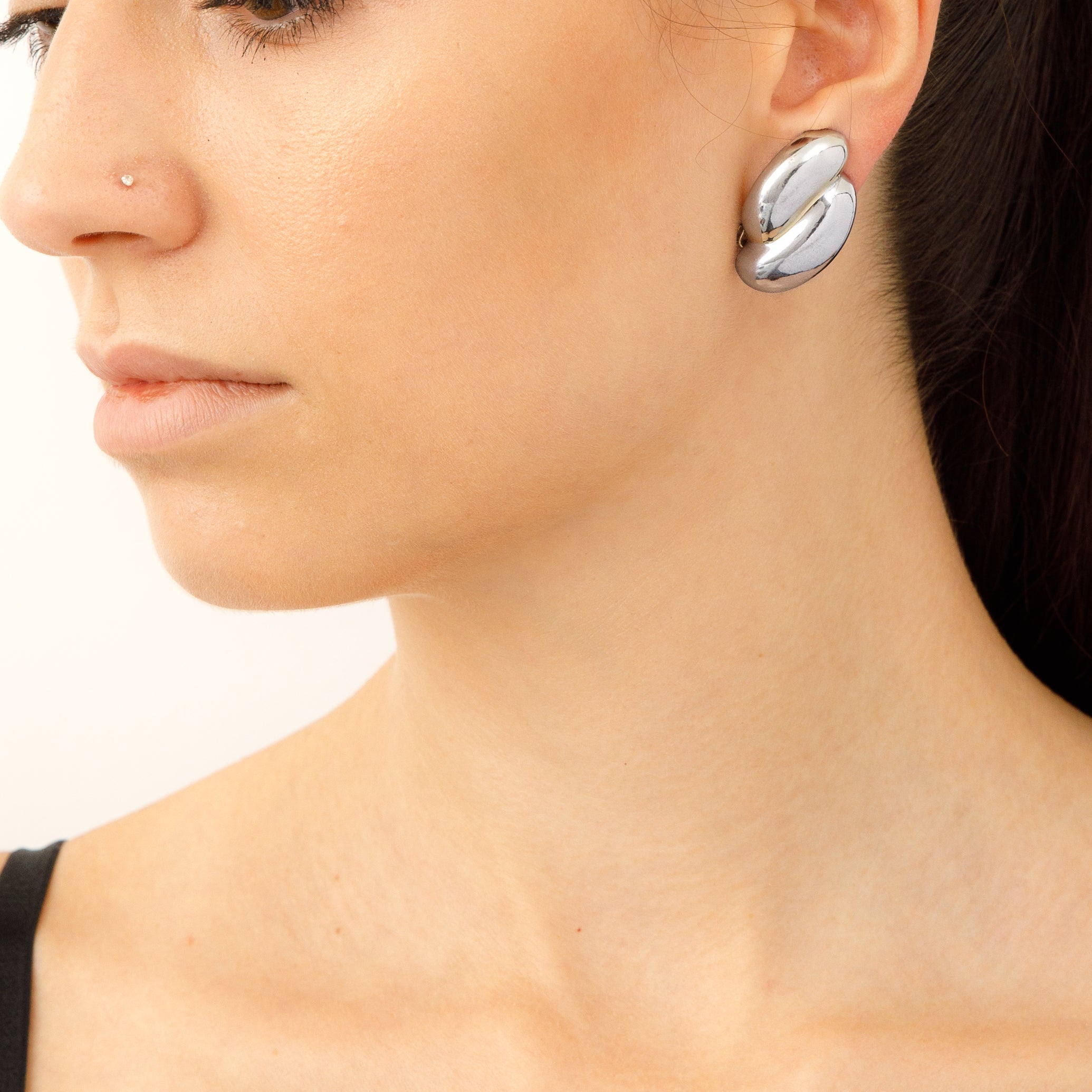 Vintage Carolee hammered silver tone earrings on model