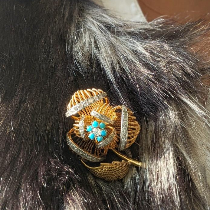 Mid-century flower fur clip attached to a fur coat.