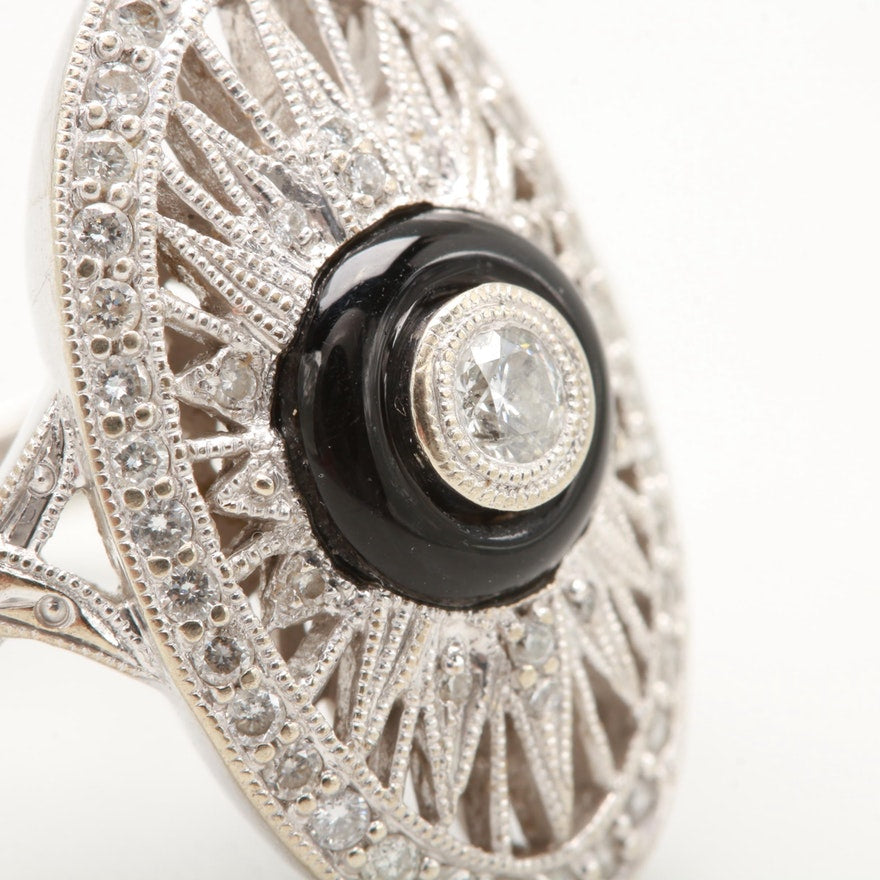 Openwork white gold ring with diamonds and drilled onyx cabochon centre.