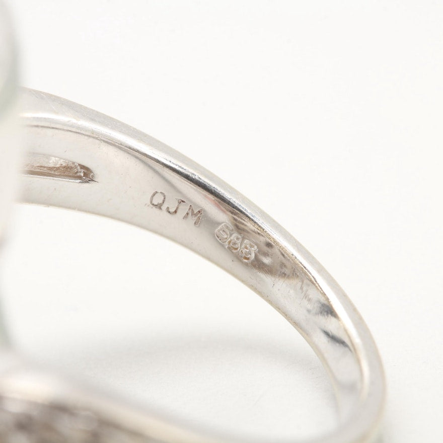 Hallmarks on white gold diamond ring reading ‘QJM 585’.