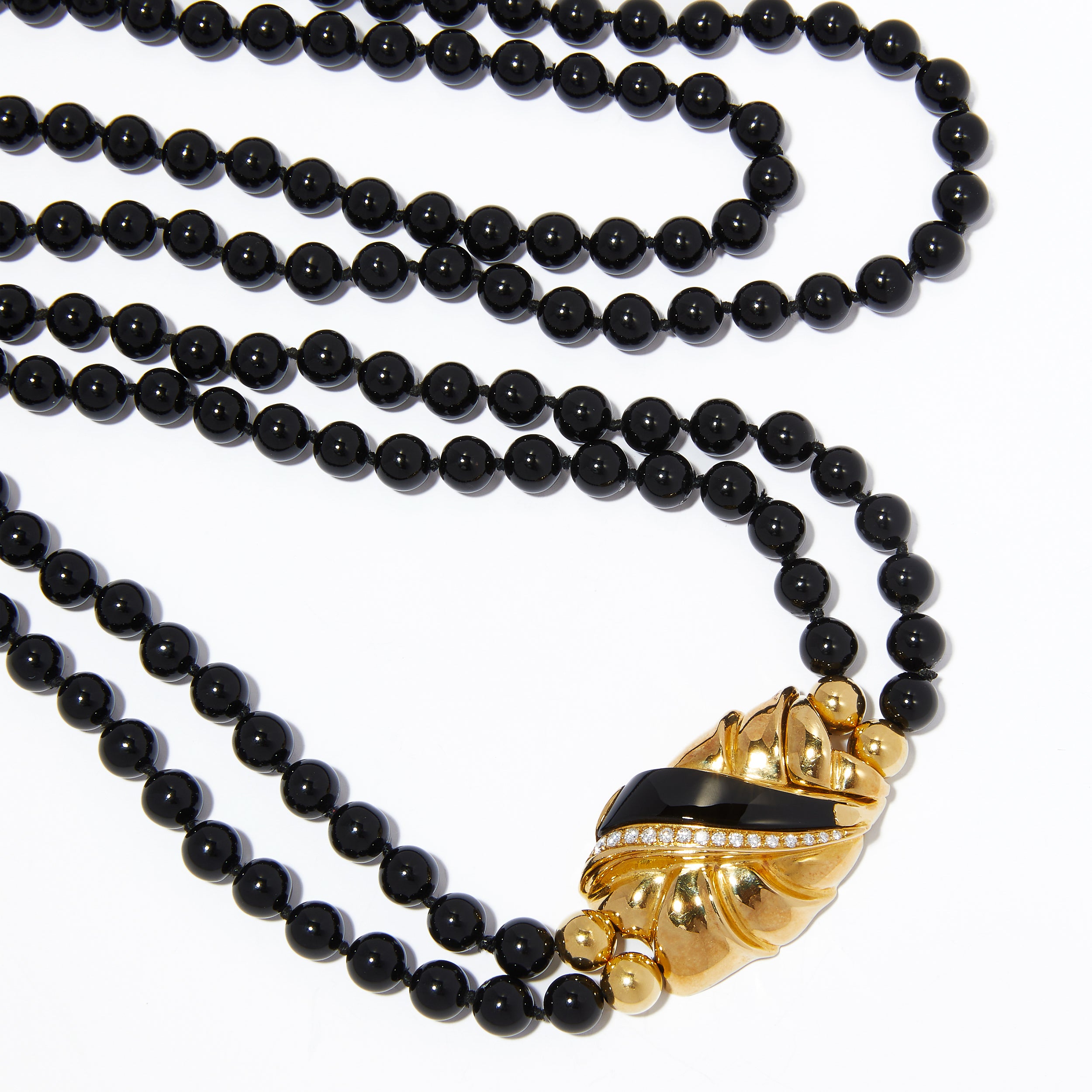 Double-strand black onyx beaded necklace with 18ct gold and diamond clasp.
