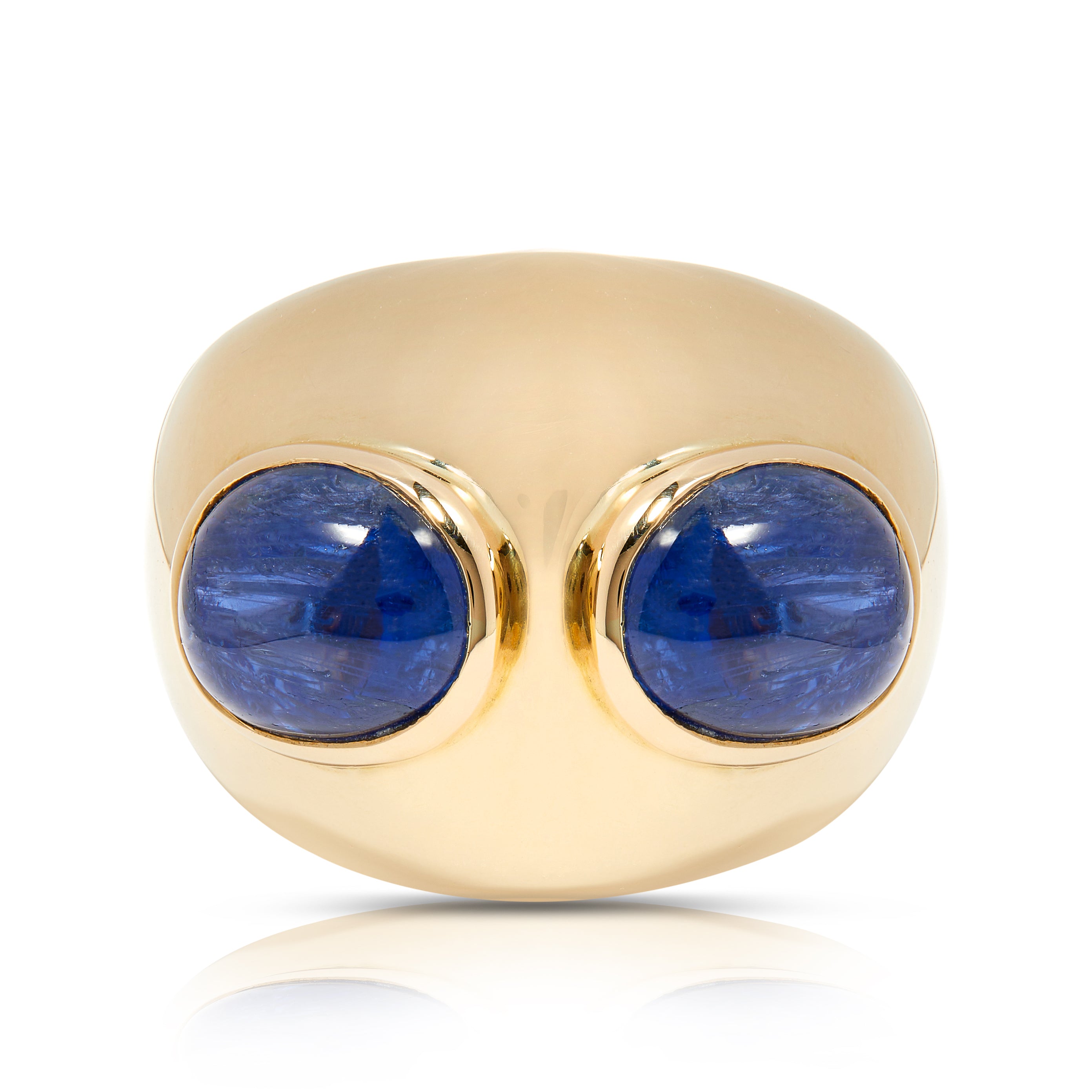 Statement gold cocktail ring with two blue sapphires.