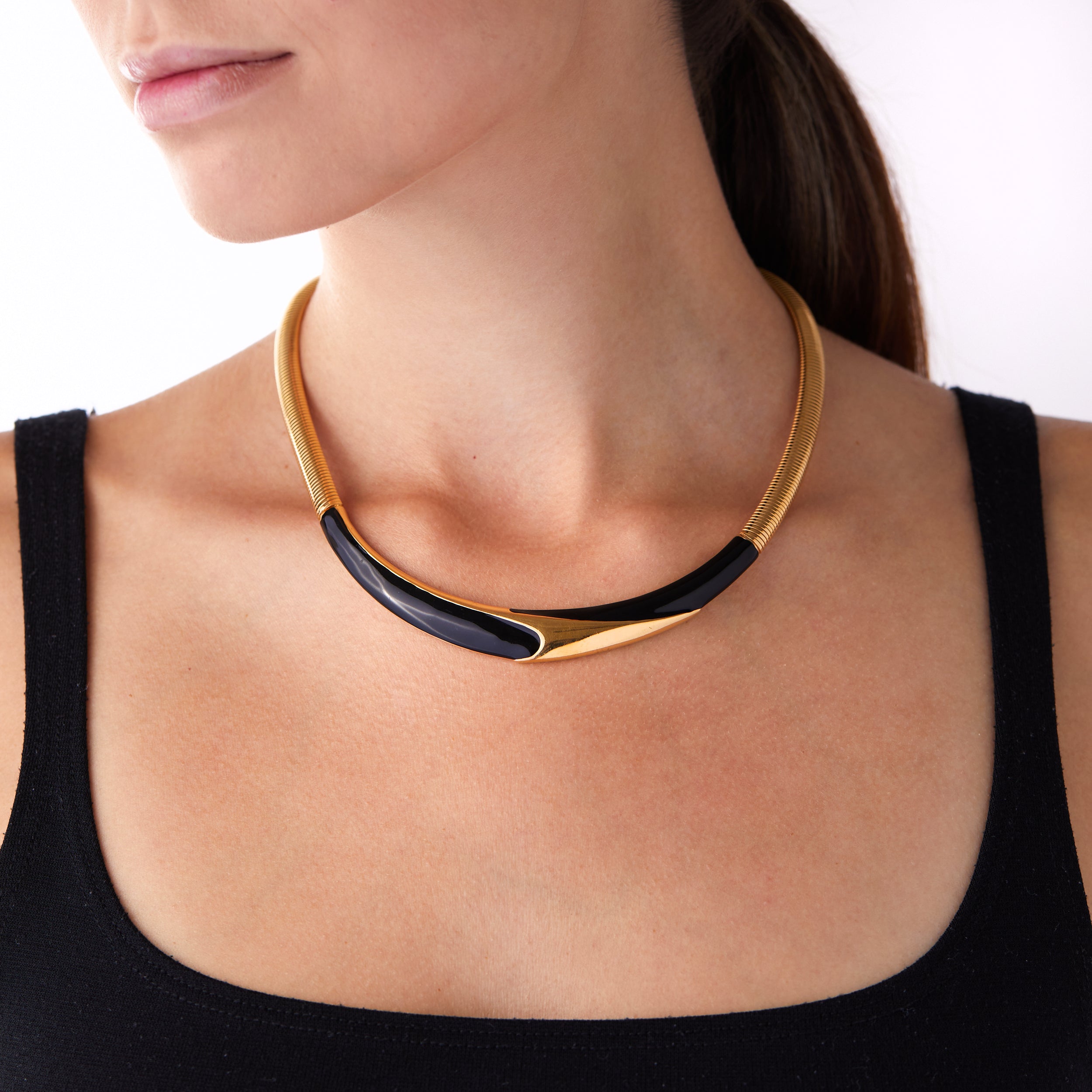 Woman’s neck wearing vintage Monet omega necklace