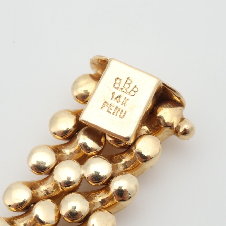 Hallmarks on closure side of gold link bracelet reading ‘BBB 14K PERU’
