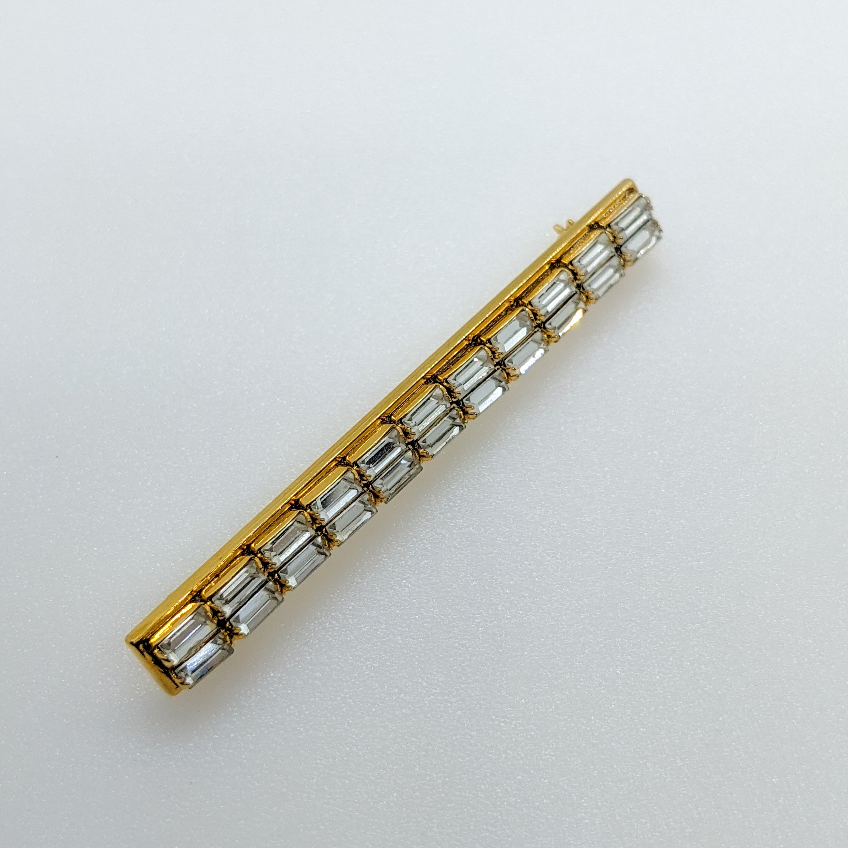 Side view of vintage bar pin brooch with baguette crystals 