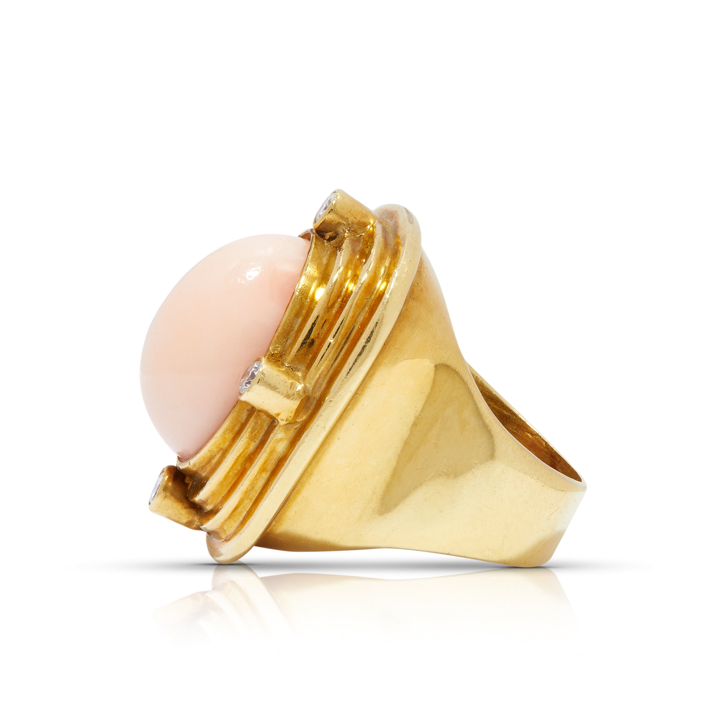 Side view of 18ct gold ring with angel skin coral and diamonds.