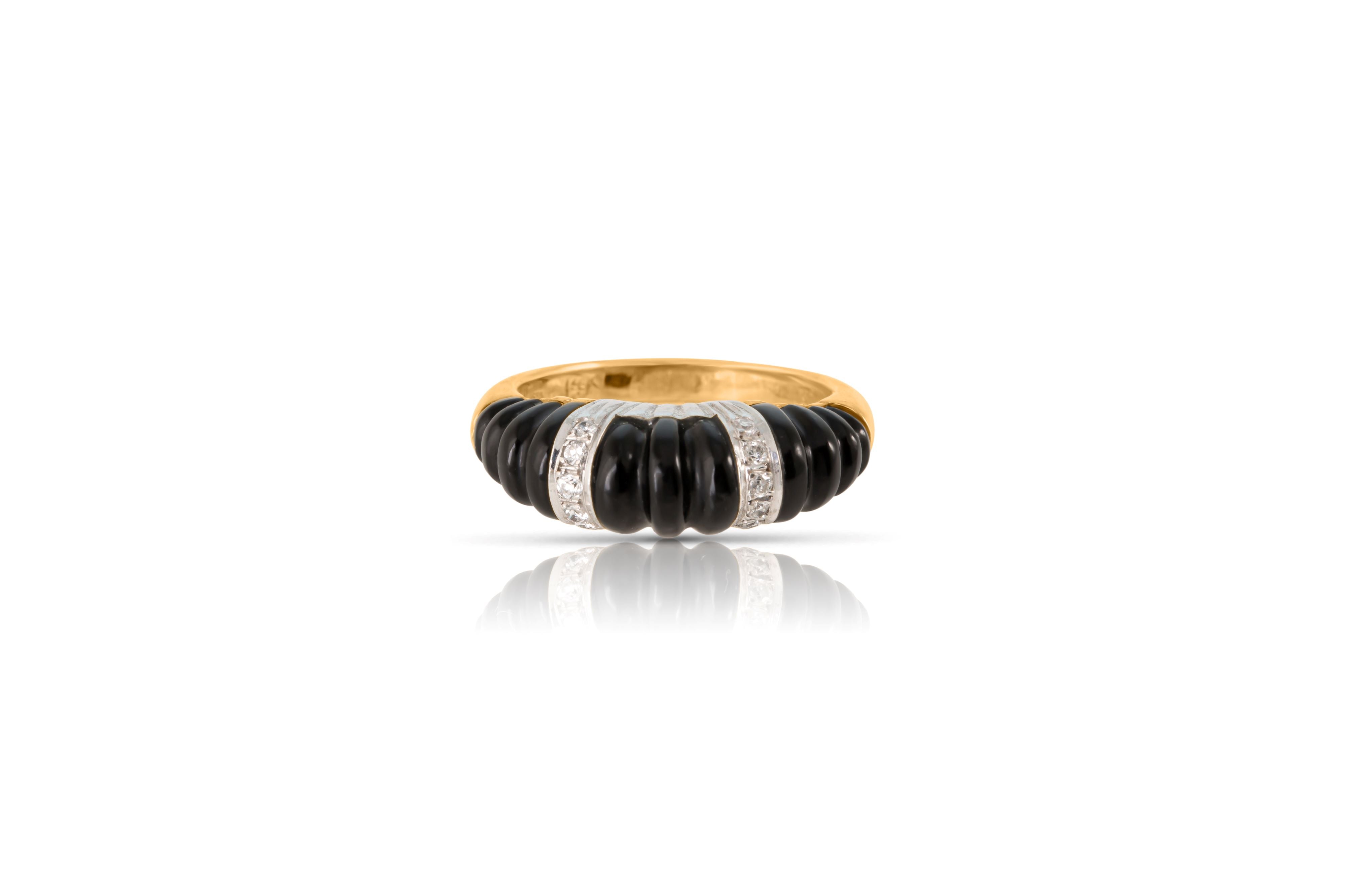 Top view of gold and carved black onyx dome ring with diamonds.