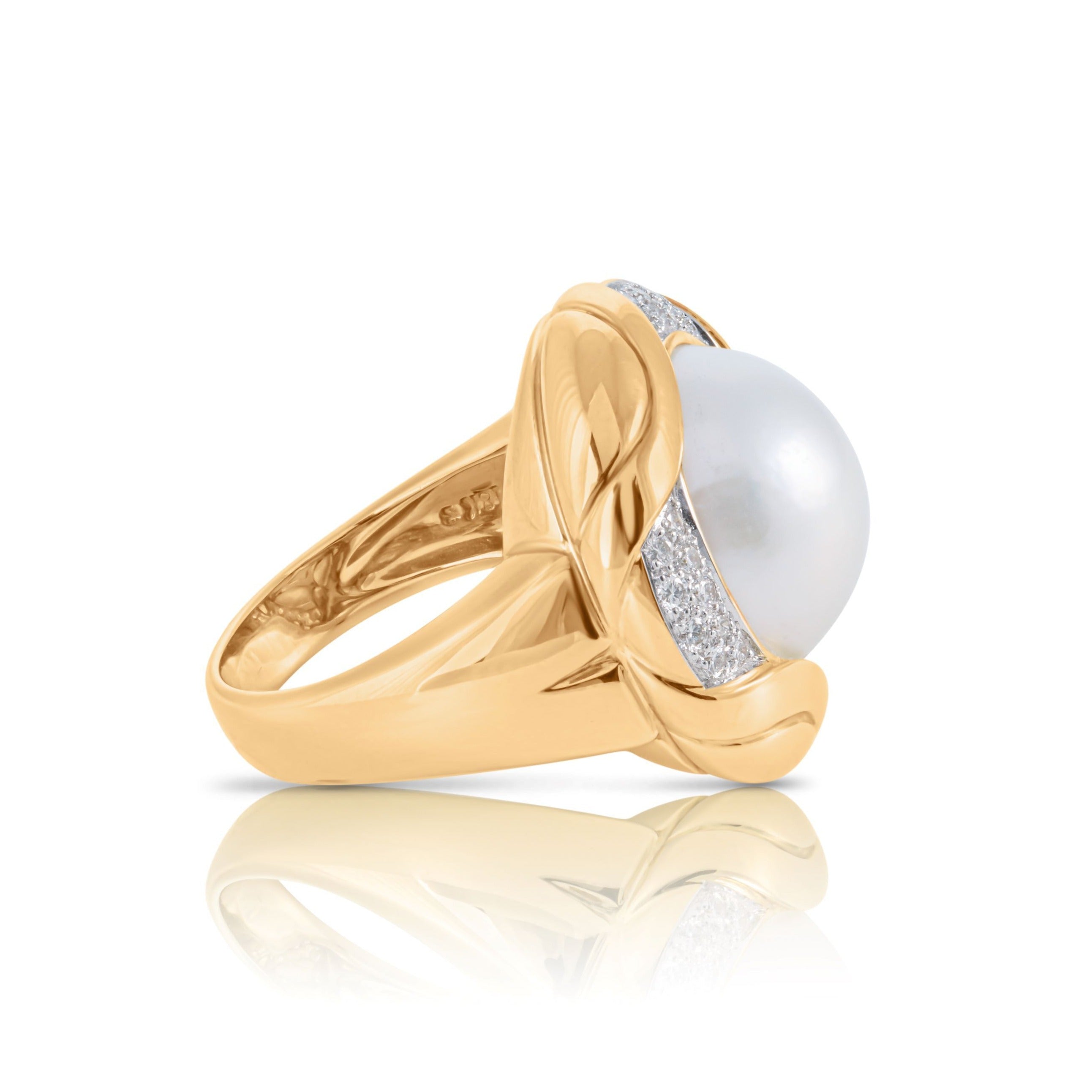 Side view of 18ct gold ring with cultured pearl and diamonds.