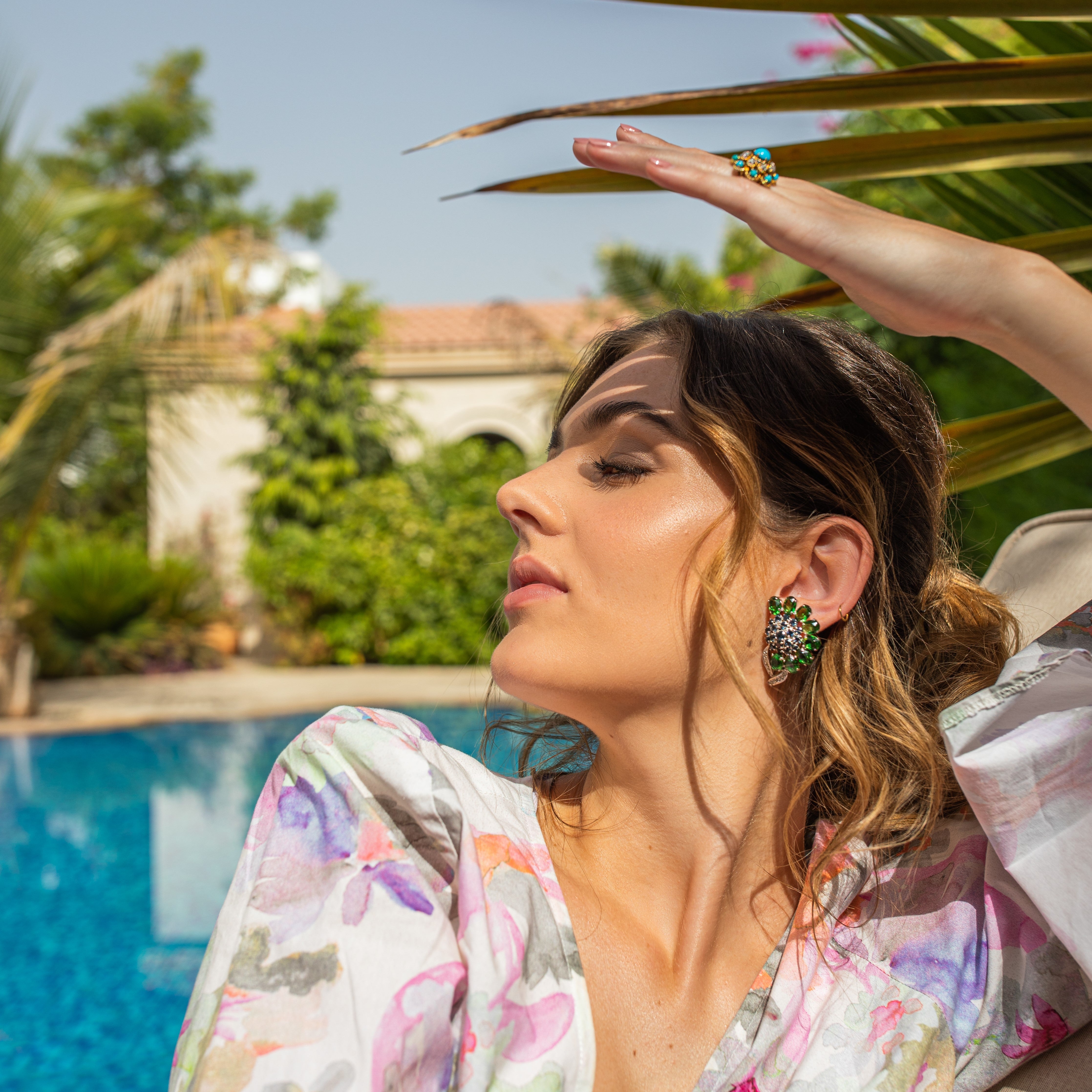 Woman by the pool wearing vintage flower clip earrings
