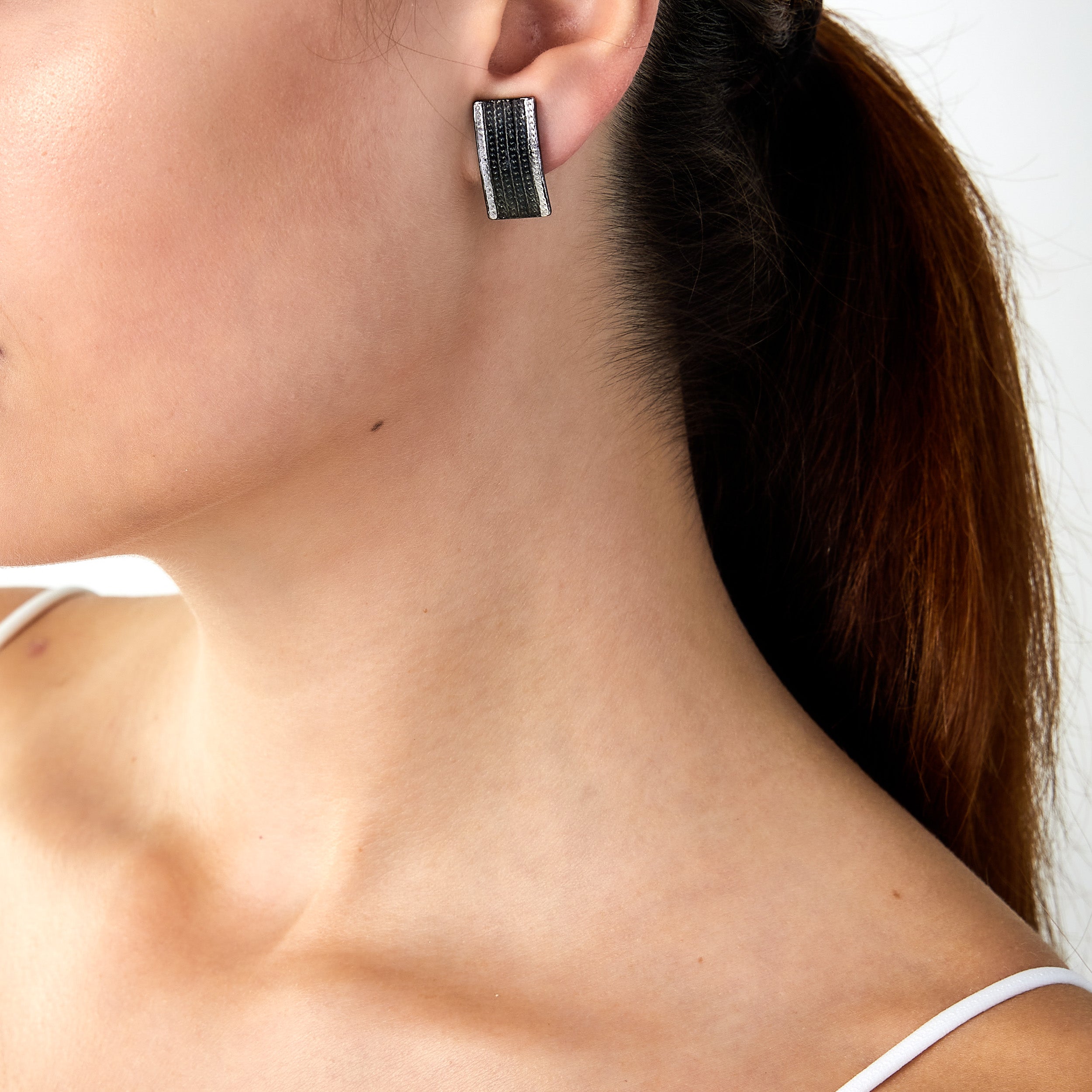 Vintage Trifari oxidised earrings worn on a woman’s ear
