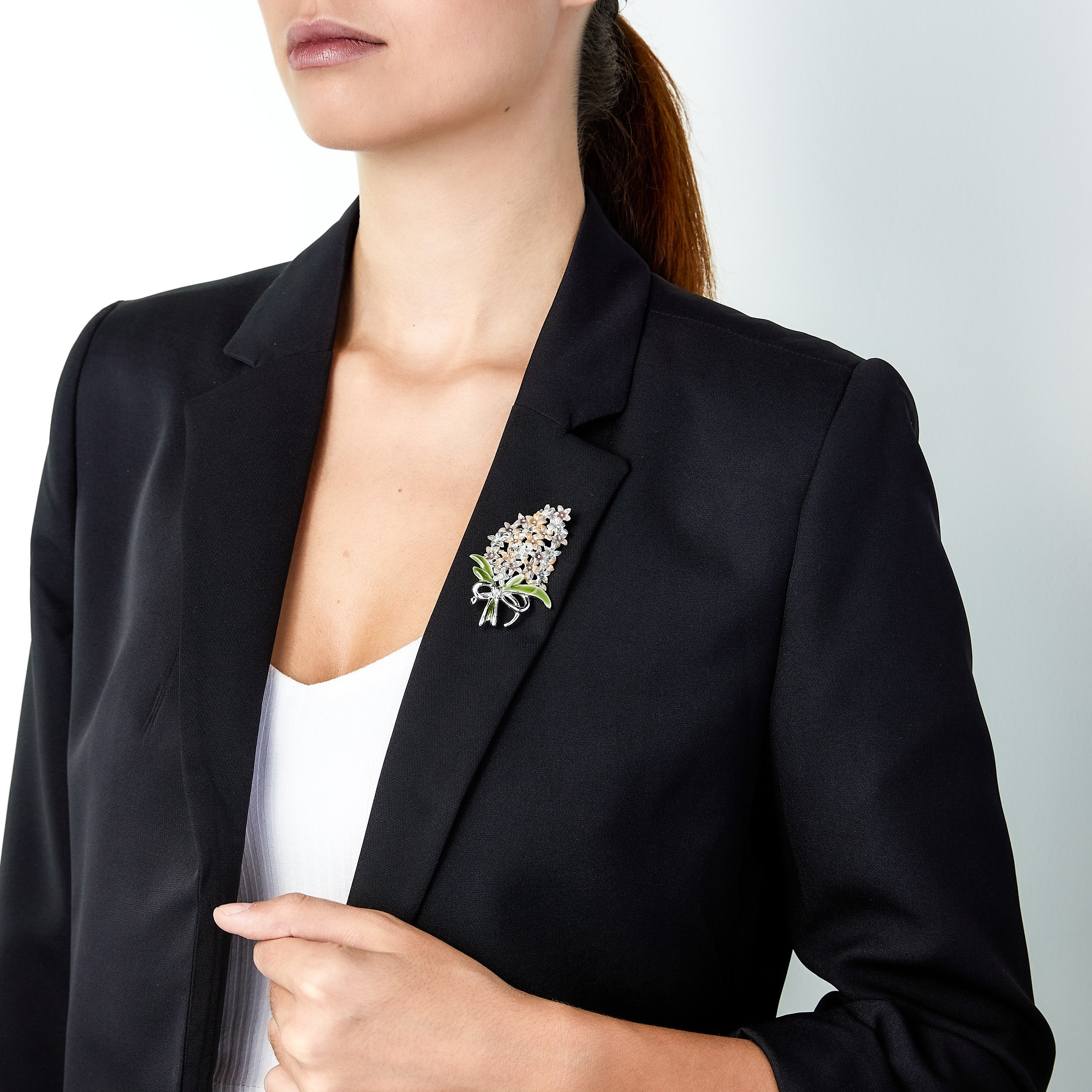 Vintage flower bouquet brooch pin worn on woman’s lapel