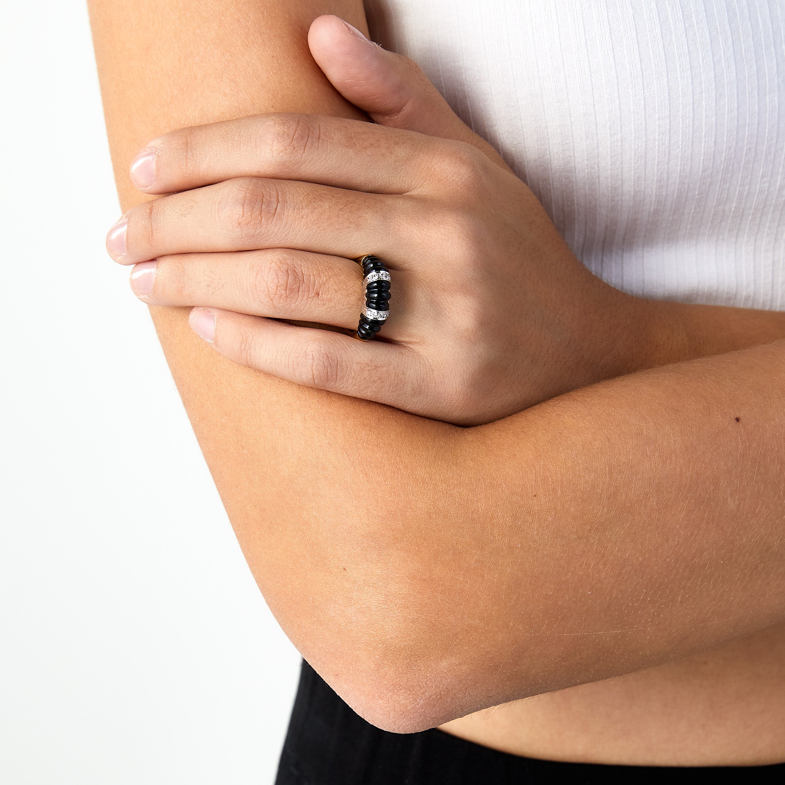 1980s-1990s carved onyx gold dome ring worn on woman’s hand. 