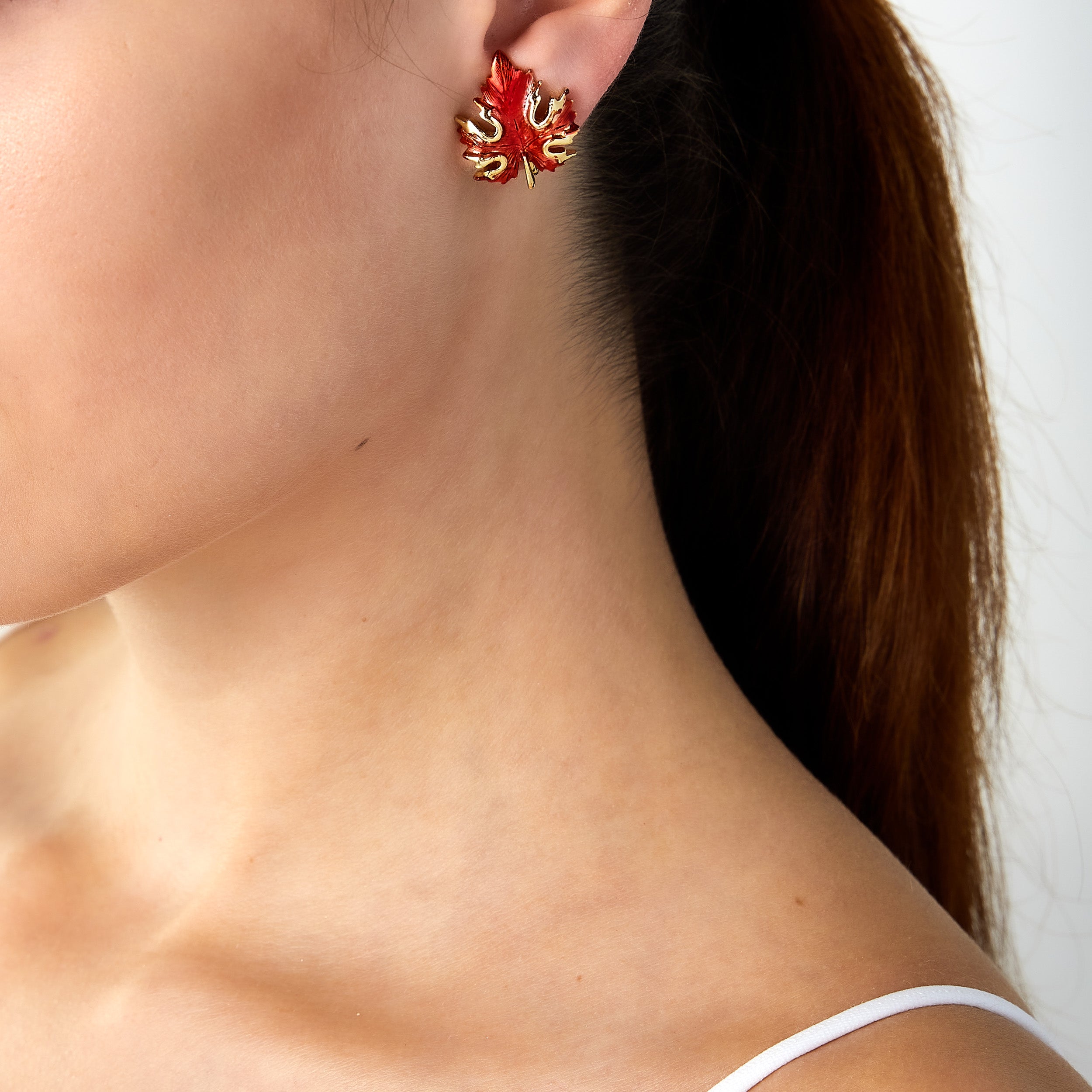 Vintage maple leaf clip earrings worn on woman’s ear