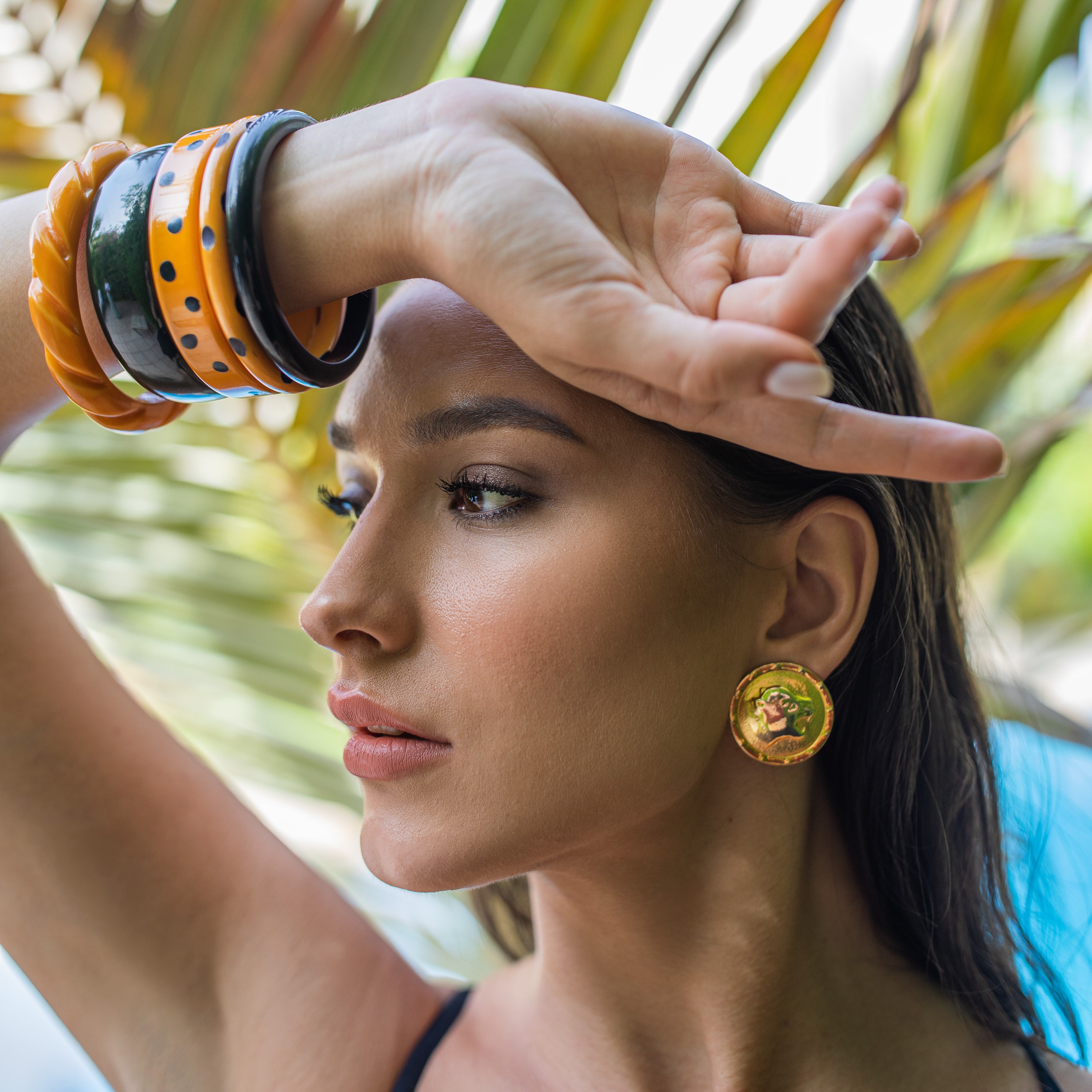 Woman wearing costume leopard head clip-on earrings