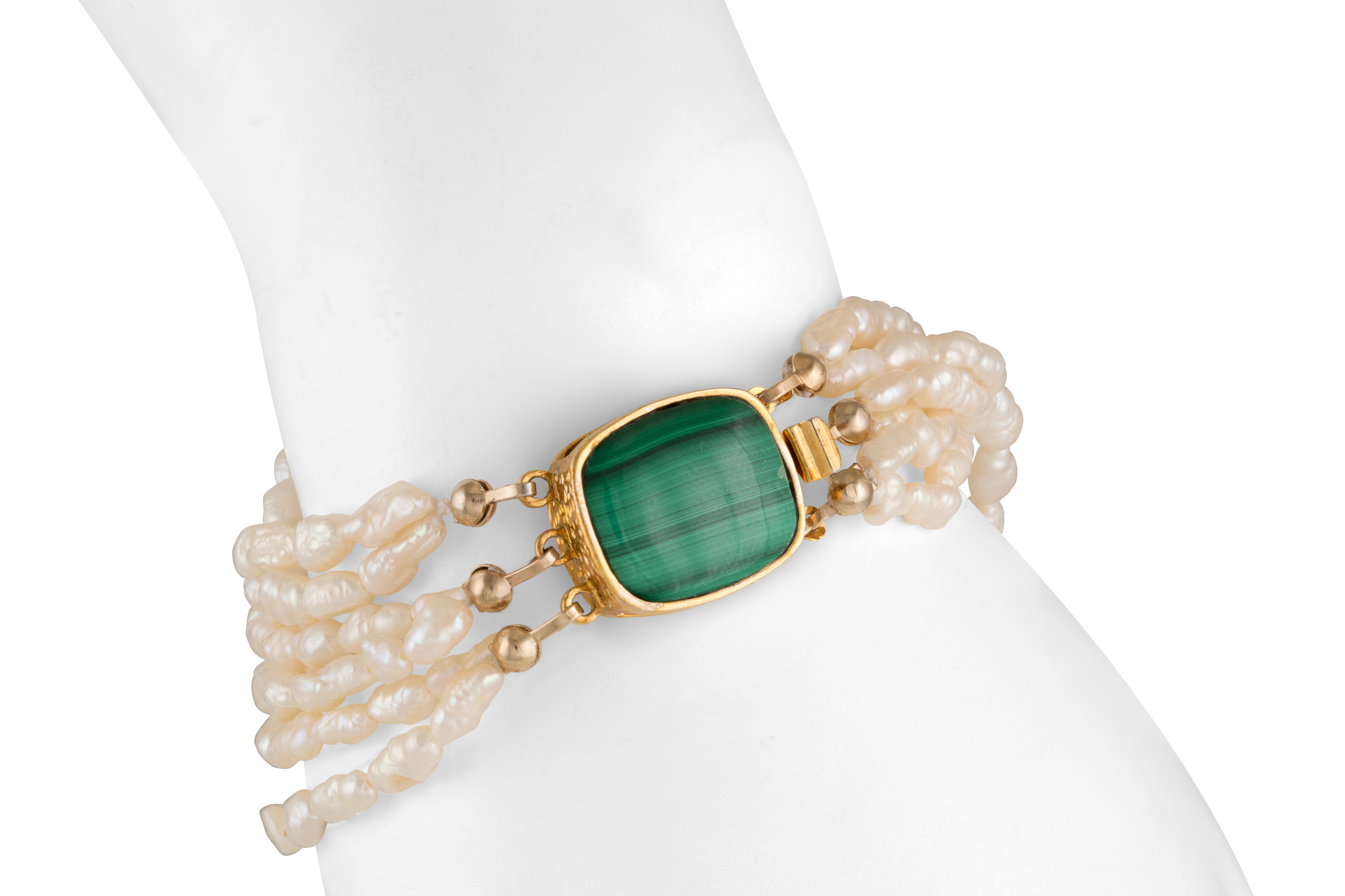 Estate pearl bracelet with a synthetic malachite worn on the wrist