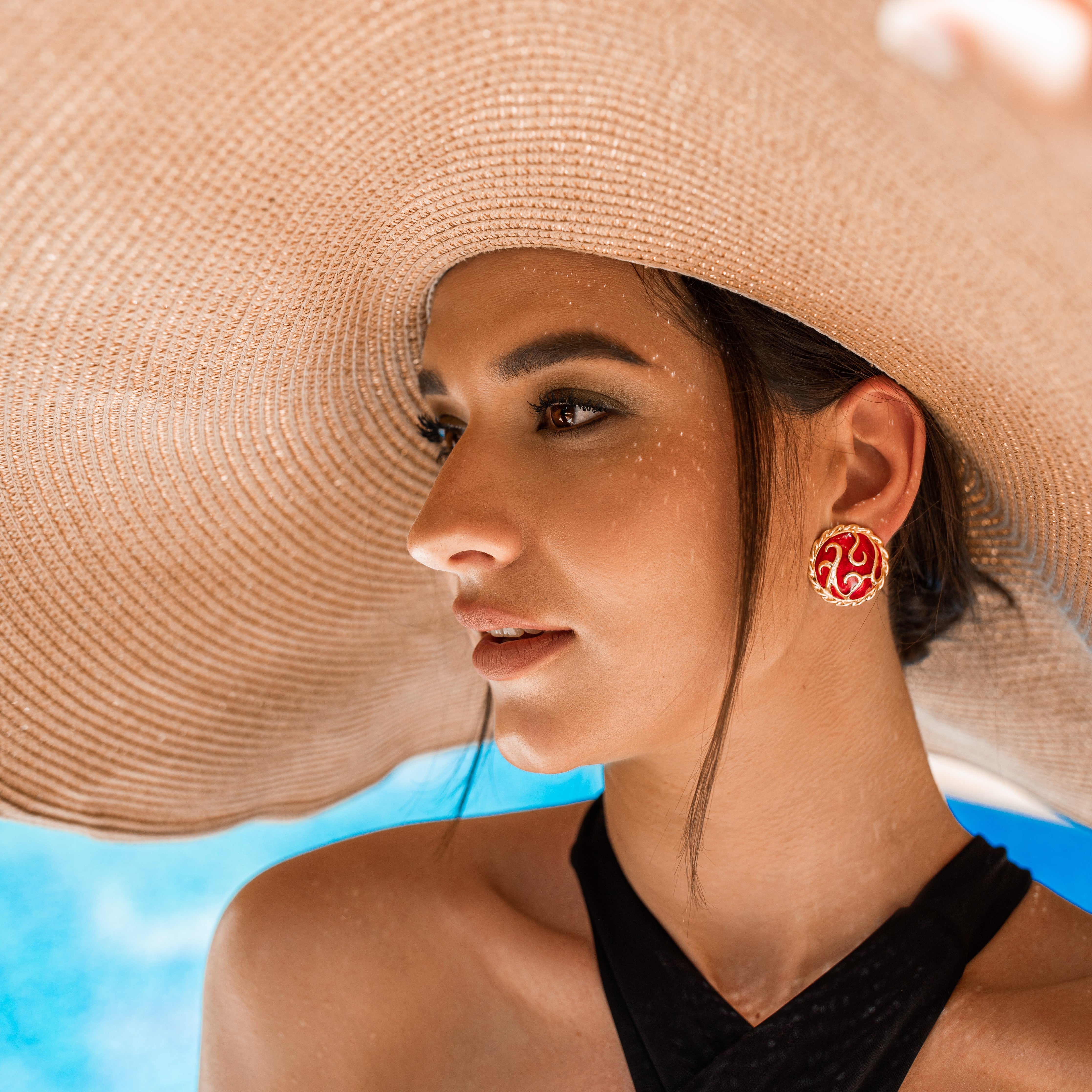 Woman by the pool wearing vintage costume clip earrings